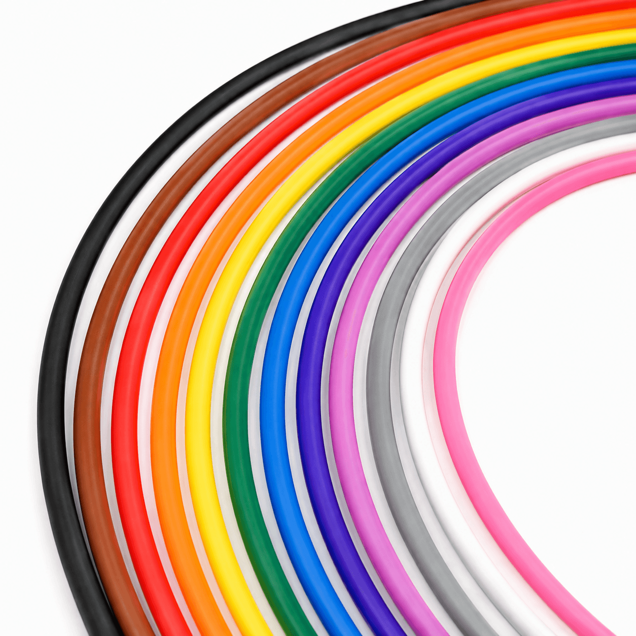 Vibrant, multi-colored flexible tubes arranged in concentric arcs against a plain white background.